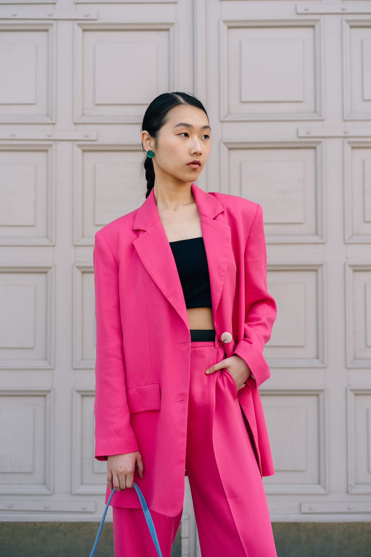 Woman in Pink Blazer Standing Beside a Wall