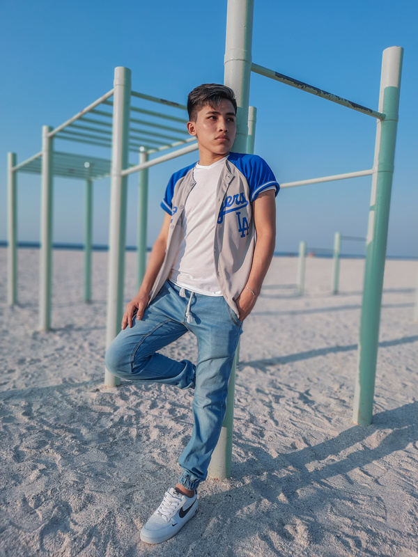 Teenage Boy in White Shirt and Denim Jogger Pants